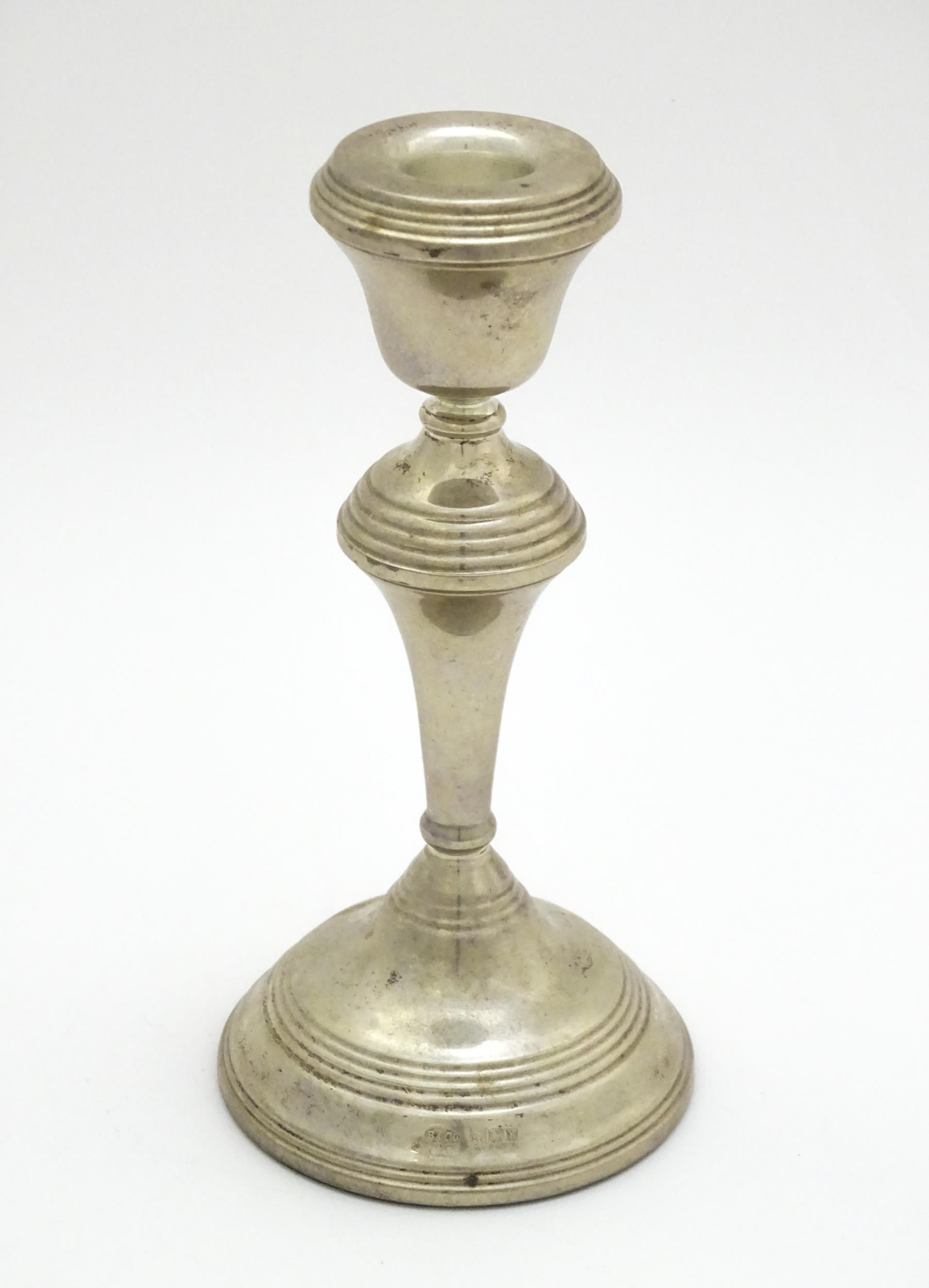 A silver candlestick hallmarked Birmingham 1973, maker W. I. Broadway. Approx. 7 1/4" high Please