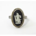 A silver ring set with Wedgwood Jasperware cabochon. Ring size approx. L Please Note - we do not