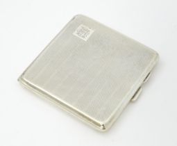 A silver cigarette case with engine turned decoration and gilded interior, hallmarked Birmingham