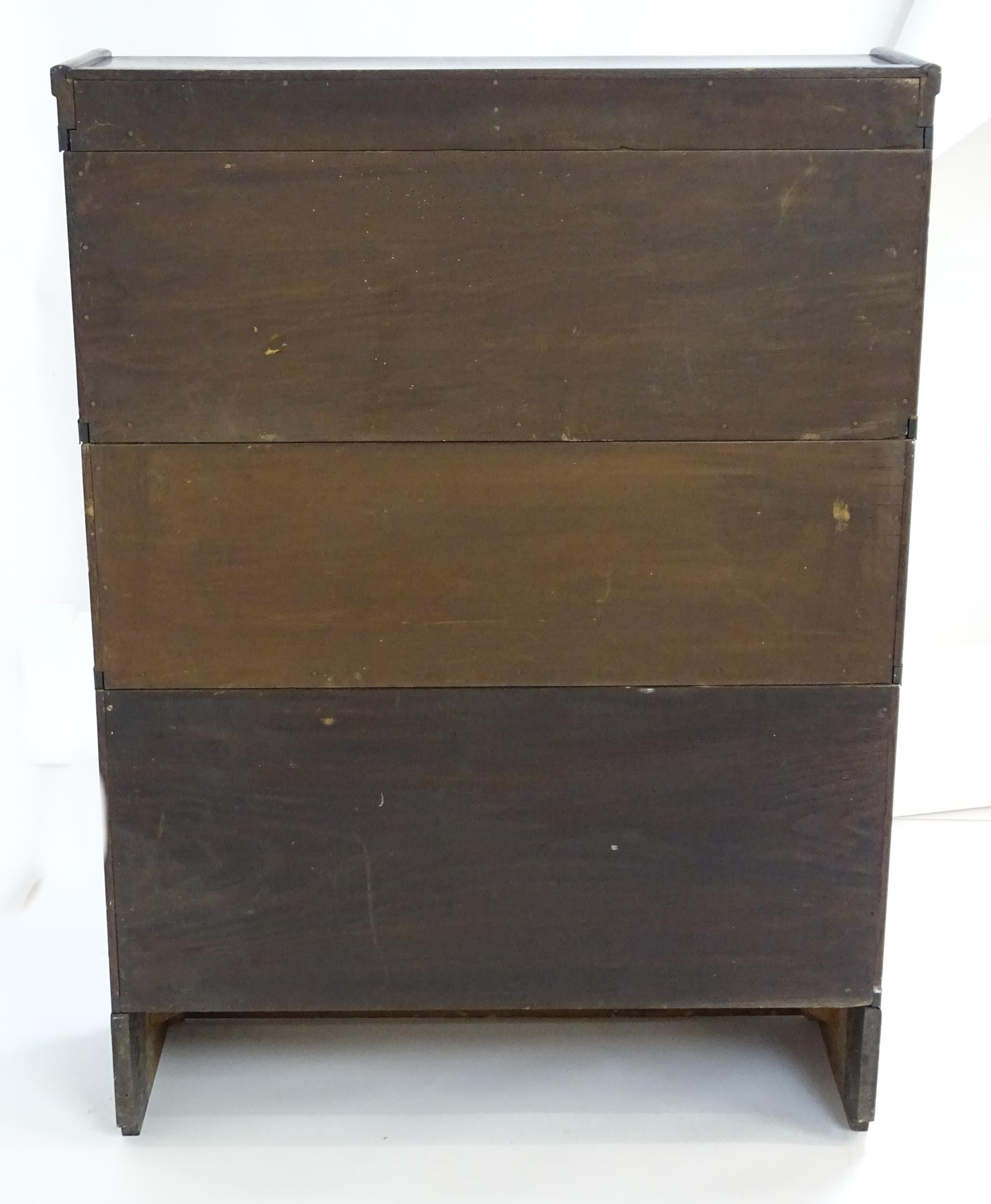 An early / mid 20thC oak Globe Wernicke bookcase with three glazed tiers above a shaped base. 34" - Image 8 of 8