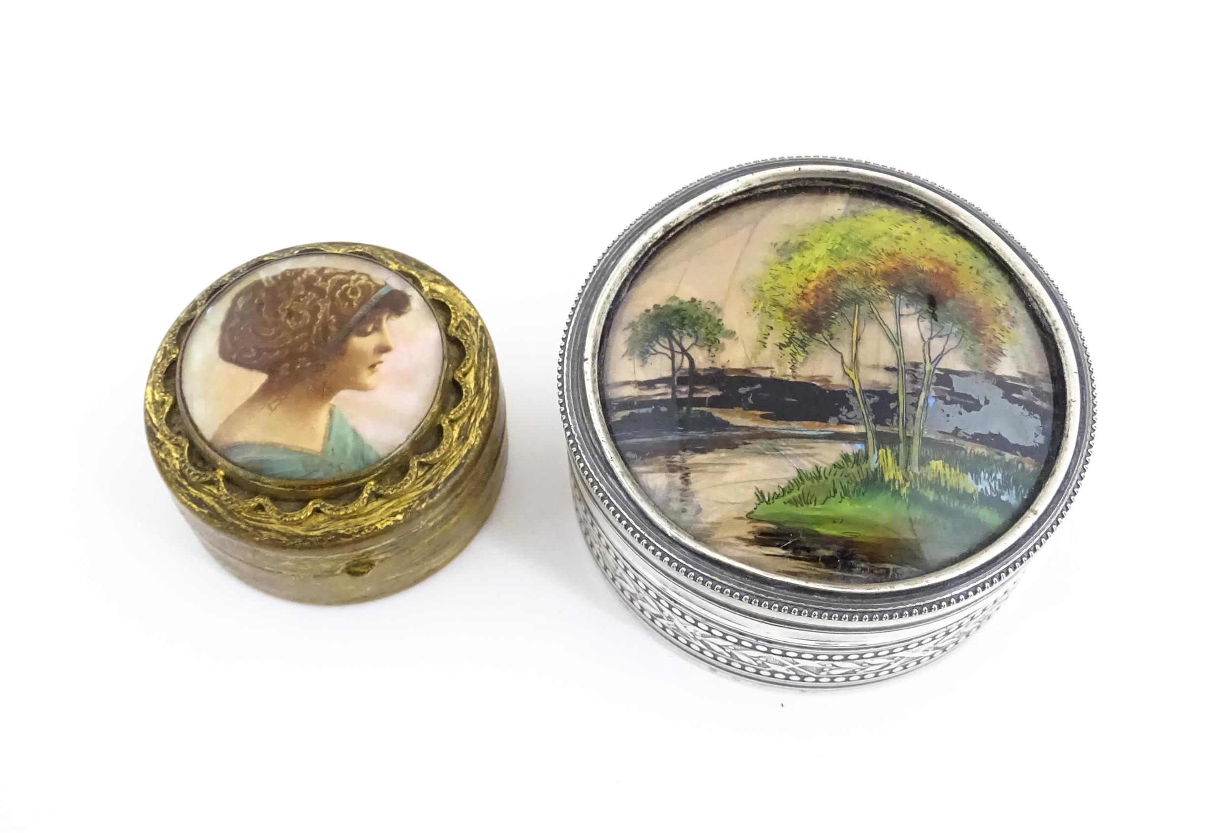 A 20thC silver plate pot and cover of circular form, the lid decorated with trees and river scene