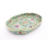 A Chinese famille rose dish with scrolling floral and foliate decoration. Character marks under.