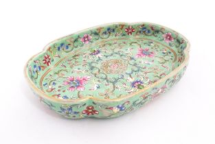 A Chinese famille rose dish with scrolling floral and foliate decoration. Character marks under.