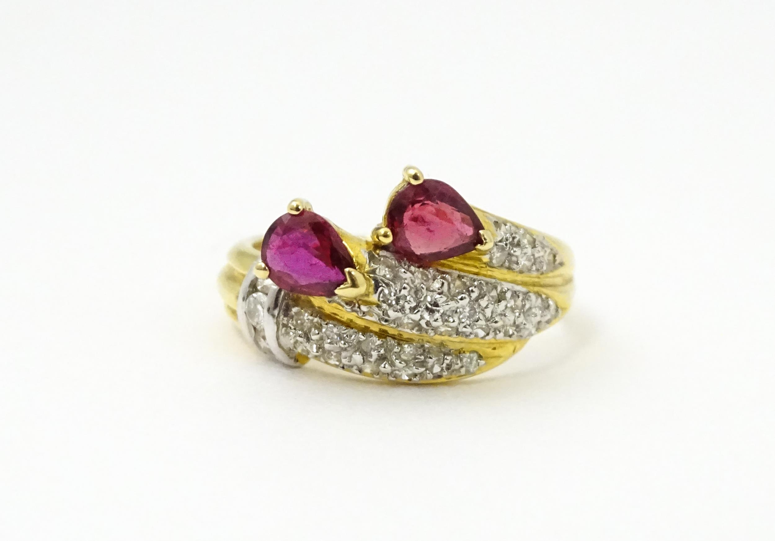 An 18ct gold ruby and diamond ring set with two rubies and a profusion of diamonds. Ring size - Image 2 of 6