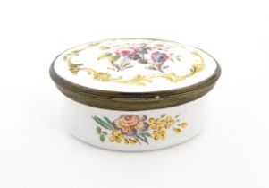 A 19thC snuff box of oval form with enamel decoration depicting flowers and foliage. Approx. 2 3/