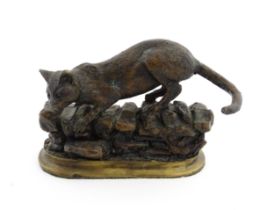 A 20thC cast bronze model of a cat on a stone wall, after Jules Moigniez. Cast signature to reverse.