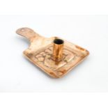 An Arts and Crafts copper chamber stick / candle holder with hammered decoration and embossed fish