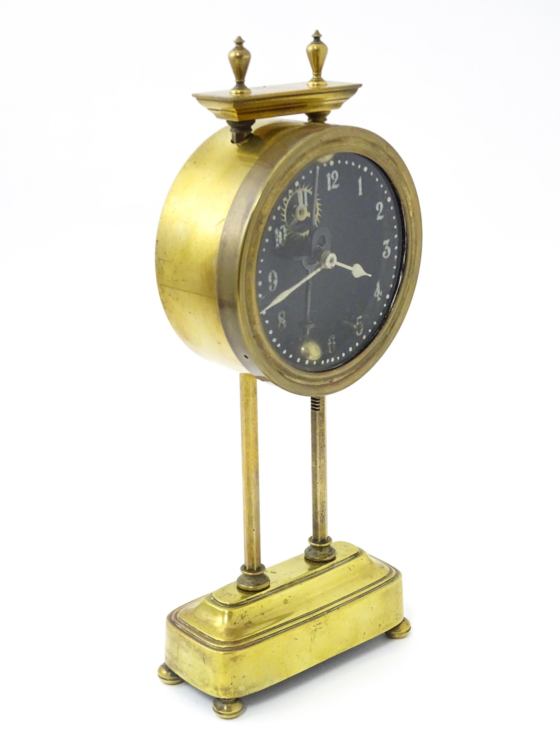 A brass cased Gravity clock with dial with Arabic numerals and having exposed escapement. Marked - Image 4 of 9