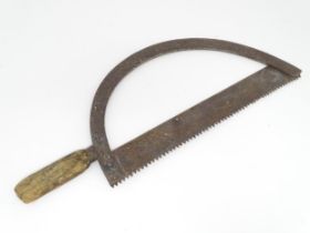 A 19thC bow saw , with arc frame and wooden handle, approx 23" long Please Note - we do not make