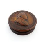 A 19thC treen snuff box of circular form the lid with a relief moulded bust of HRH George IV