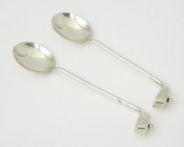 Two silver coffee spoons, the handles formed as golf clubs and balls. Hallmarked Birmingham 1922