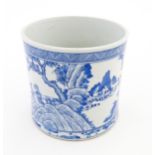 A Chinese blue and white vase / planter decorated with figures in a garden setting with a feast, and