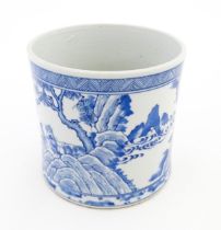 A Chinese blue and white vase / planter decorated with figures in a garden setting with a feast, and