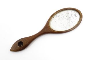 A Victorian miniature hand mirror with a mahogany surround. Approx. 4" long Please Note - we do