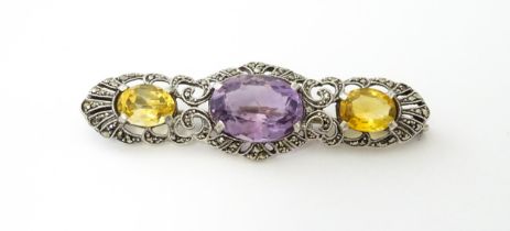 A silver brooch set with amethyst, citrine and marcasite. Approx 2 1./4" wide Please Note - we do