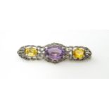 A silver brooch set with amethyst, citrine and marcasite. Approx 2 1./4" wide Please Note - we do