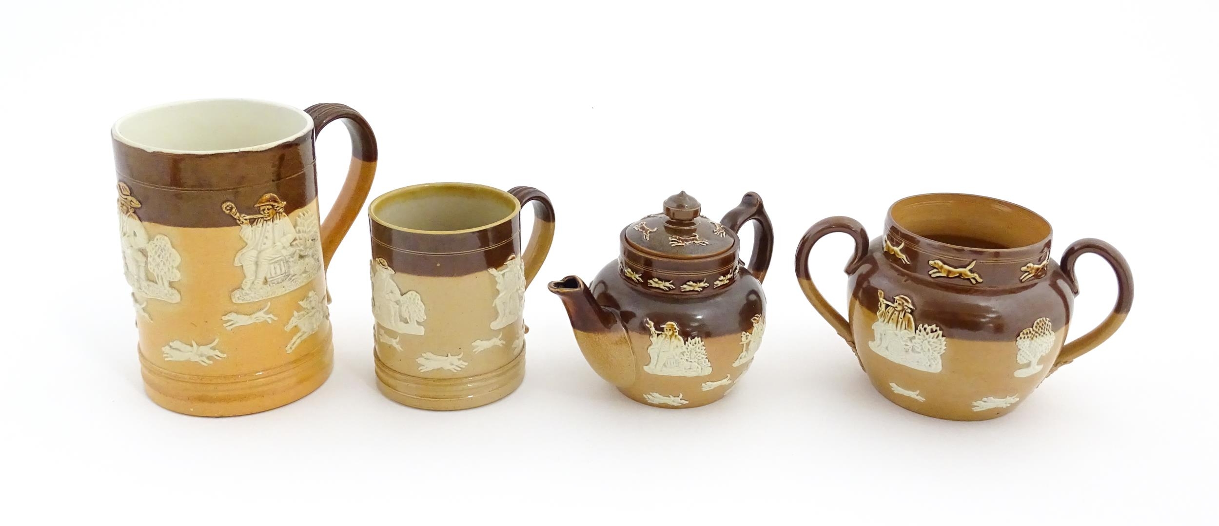 Four Royal Doulton two tone stoneware items with applied hunting detail to include tankards,