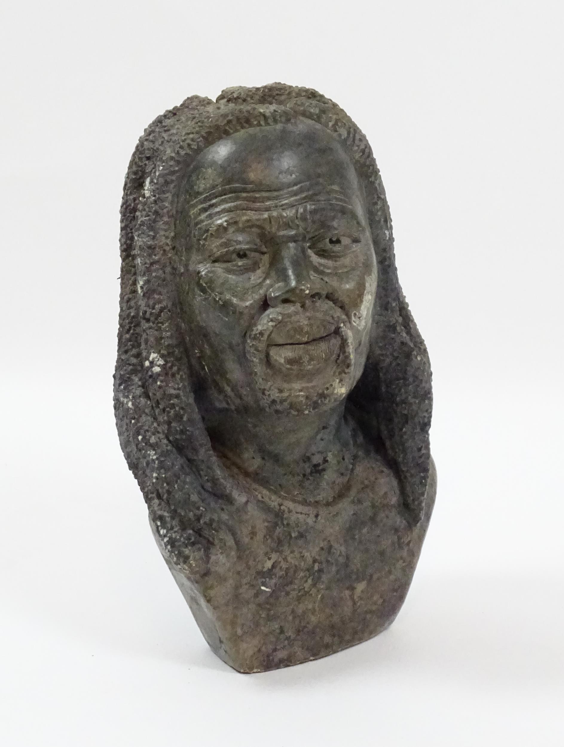 Ethnographic / Native / Tribal : An African carved soapstone bust modelled as a man with dreadlocks.