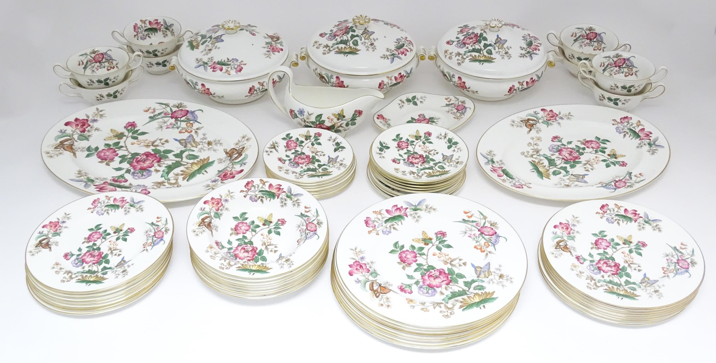 A quantity of Wedgwood dinner wares in the Charnwood pattern to include plates, twin handles soup