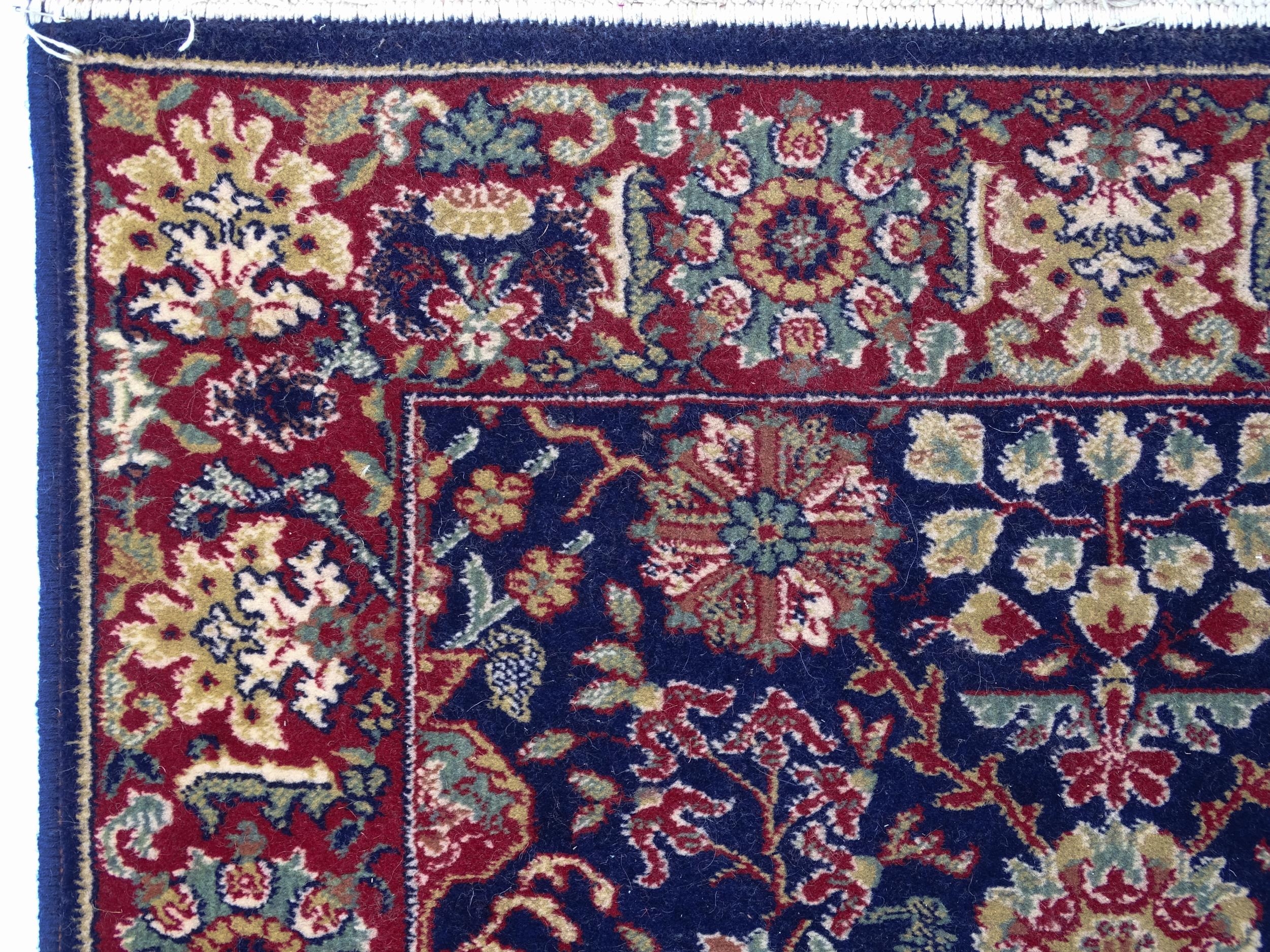 Carpet / Rug : A blue ground wool rug decorated with floral and foliate detail, further repeated - Image 3 of 9