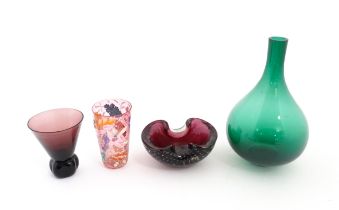 Four items of glassware to include a green bottle vase, an ashtray with controlled bubble detail,