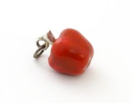 A novelty pendant charm formed as an apple with red detail. 1/2" long Please Note - we do not make
