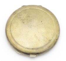 A silver compact of circular form with engine turned decoration, hallmarked Birmingham 1968, maker S