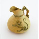 A Royal Worcester blush ivory jug with basket weave style decoration and relief lizard detail.