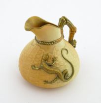 A Royal Worcester blush ivory jug with basket weave style decoration and relief lizard detail.