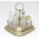 A silver plate cruet stand containing six cut glass bottles. Approx. 10 1/2" high Please Note - we