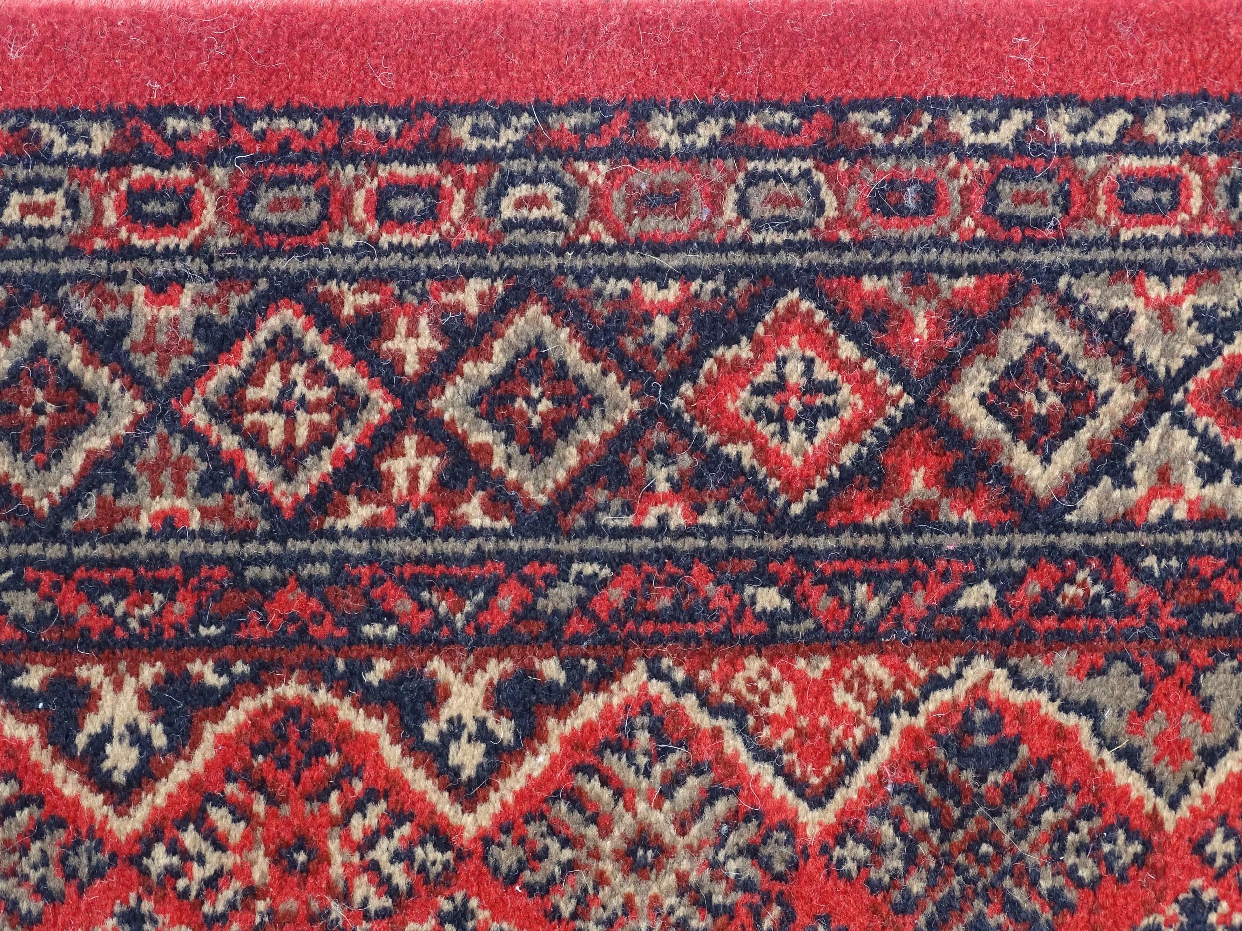 Carpet / Rug : A red ground runner with repeating motifs to centre, bordered by geometric banding. - Image 7 of 8