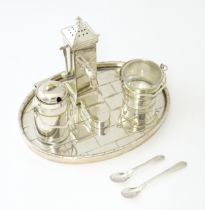 A silver plate novelty cruet set with water pump formed pepper, the salt in the form of a pail /