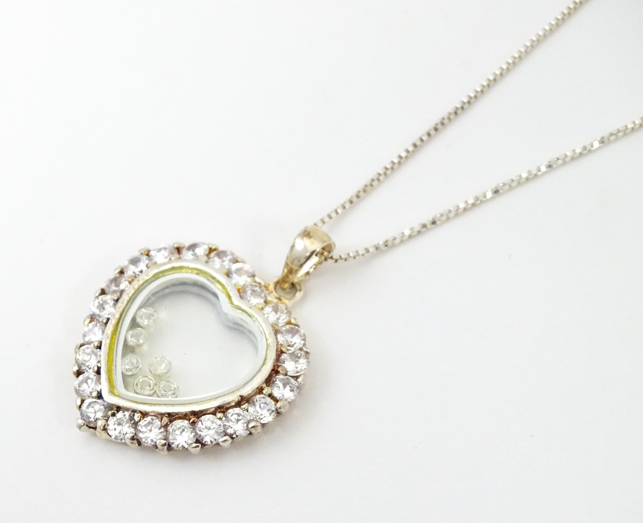 A silver chain with heart shaped locket pendant set with white stones with further white stones - Image 3 of 6