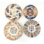 Four Japanese chargers with shaped edges decorated in the Imari palette with flowers, foliage and