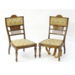 A pair of Edwardian walnut side chairs with satinwood marquetry decoration raised on tapering legs