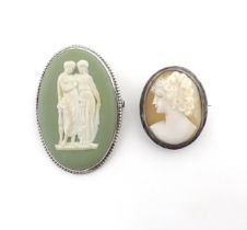 A shell carved cameo brooch with white metal mount together with a brooch set with Wedgwood