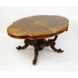 A 19thC burr walnut centre table with a moulded top above four acanthus carved supports, a large