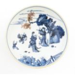 A Chinese blue and white dish / bowl decorated with figures in a landscape. Character marks under.
