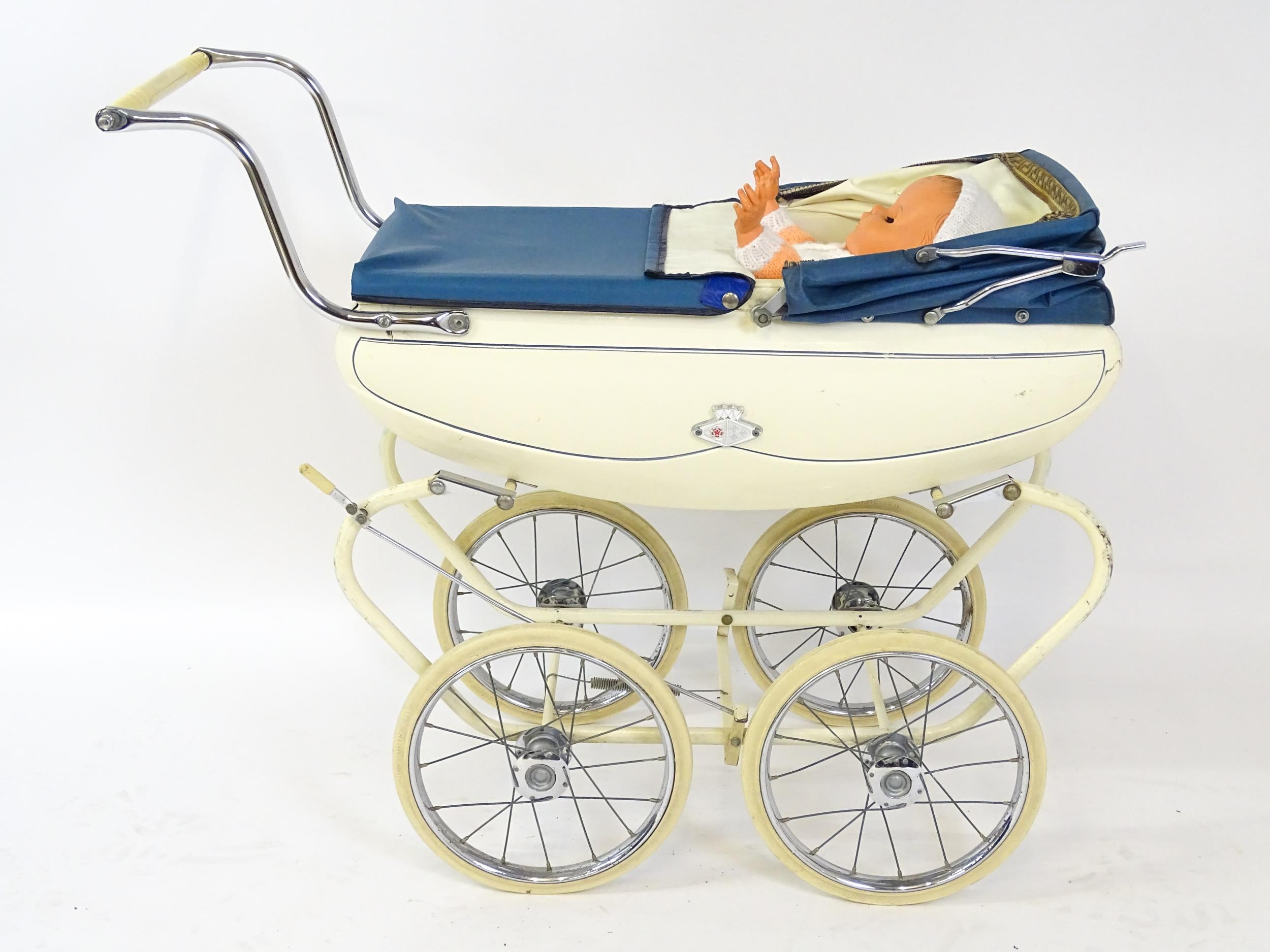 Toys: A 20thC Pedigree dolls pram with cream exterior and blue hood. Together with a plastic doll - Image 2 of 11
