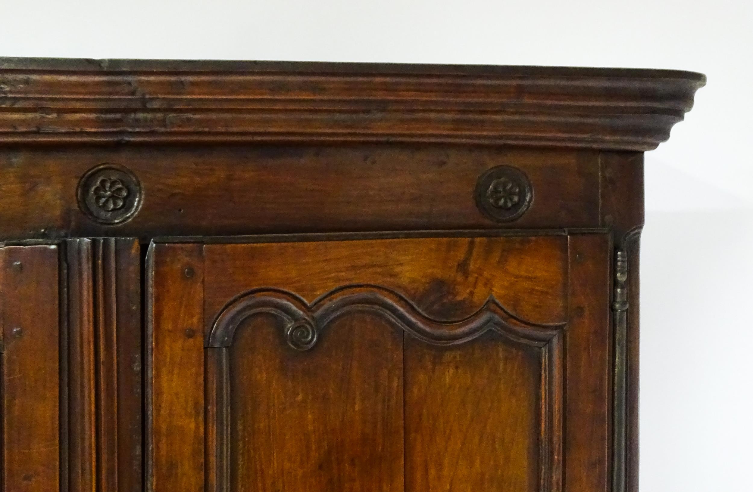 An 18thC French buffet deux corps with a moulded pediment above a floral carved frieze. The top - Image 4 of 10