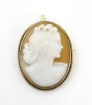 A brooch / pendant set with Classical cameo in a yellow metal mount. Approx. 1 1/2" long Please Note