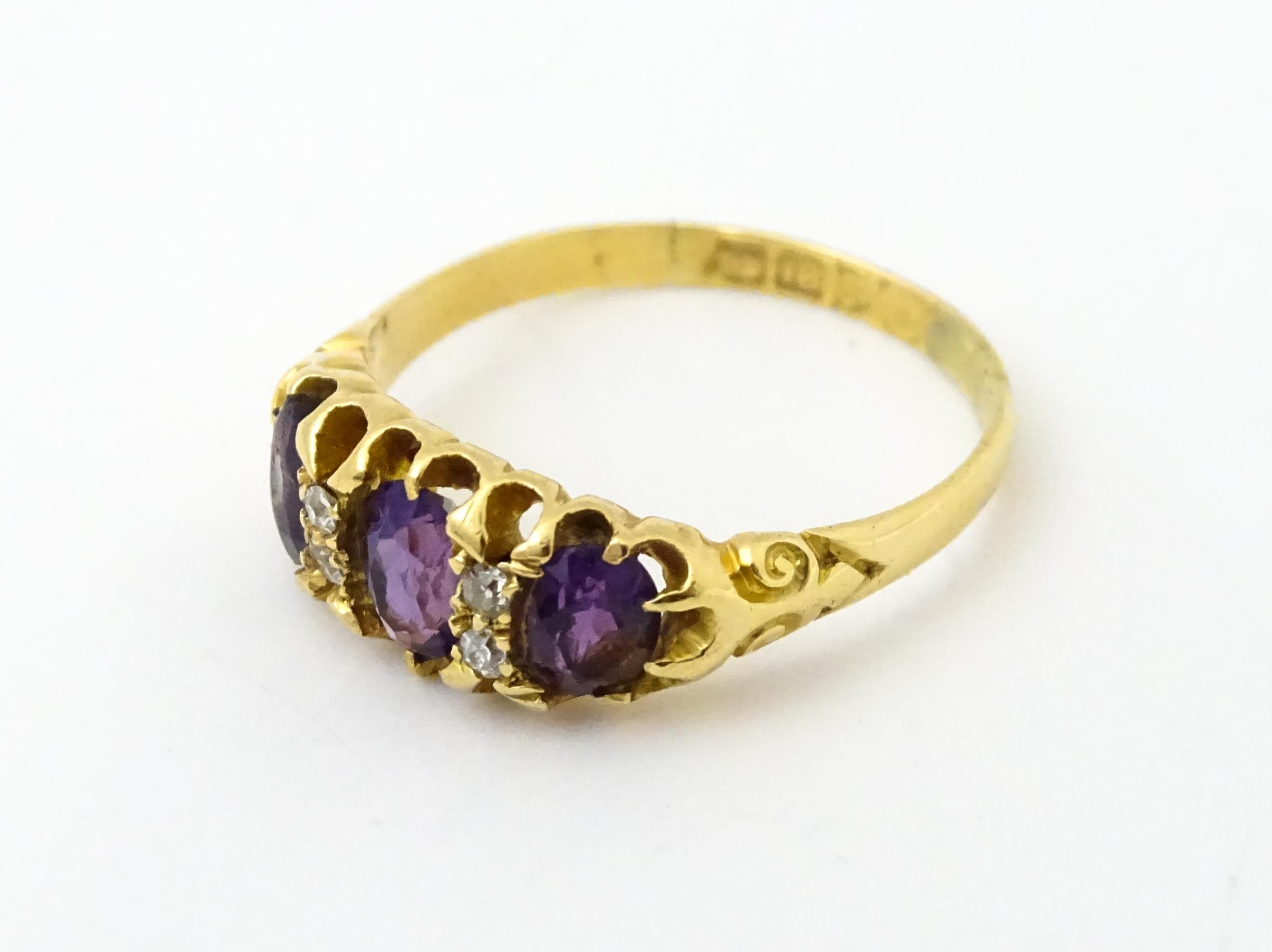 An 18ct gold ring set three graduated amethyst and four diamonds. Ring size approx. Q Please - Image 4 of 7