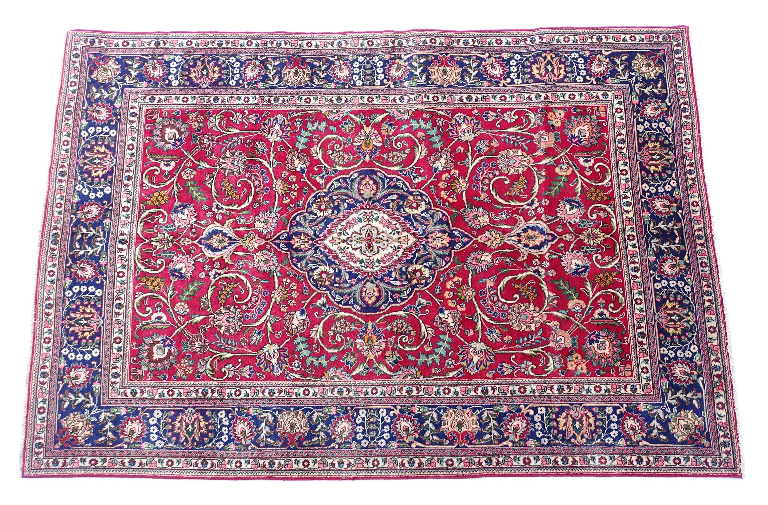 Carpet / Rug: A North West Persian Tabriz carpet the red ground with central cream and blue