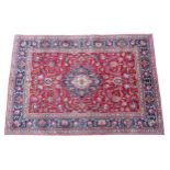 Carpet / Rug: A North West Persian Tabriz carpet the red ground with central cream and blue