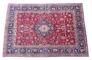 Carpet / Rug: A North West Persian Tabriz carpet the red ground with central cream and blue