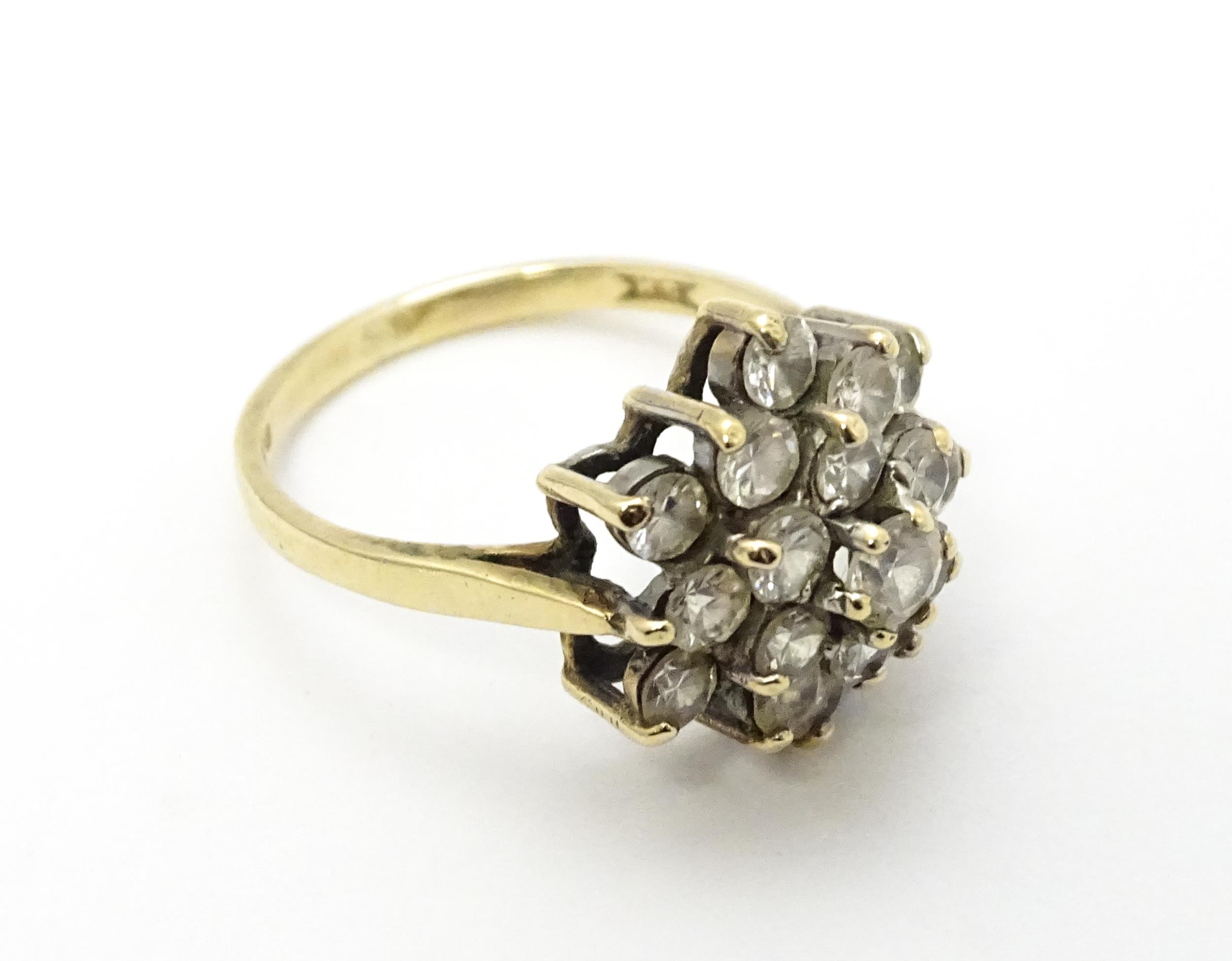 A 9ct gold ring set with diamonds in a floral cluster setting. Ring size approx. M Please Note - - Image 6 of 8