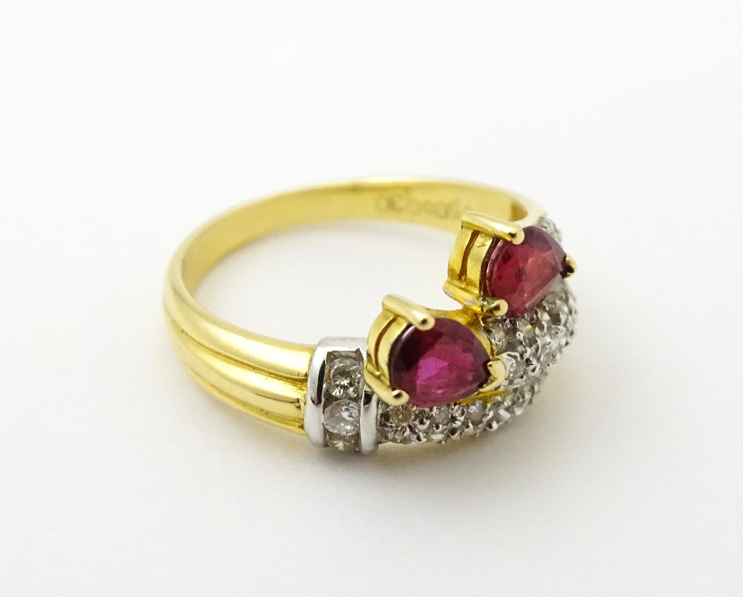 An 18ct gold ruby and diamond ring set with two rubies and a profusion of diamonds. Ring size - Image 3 of 6