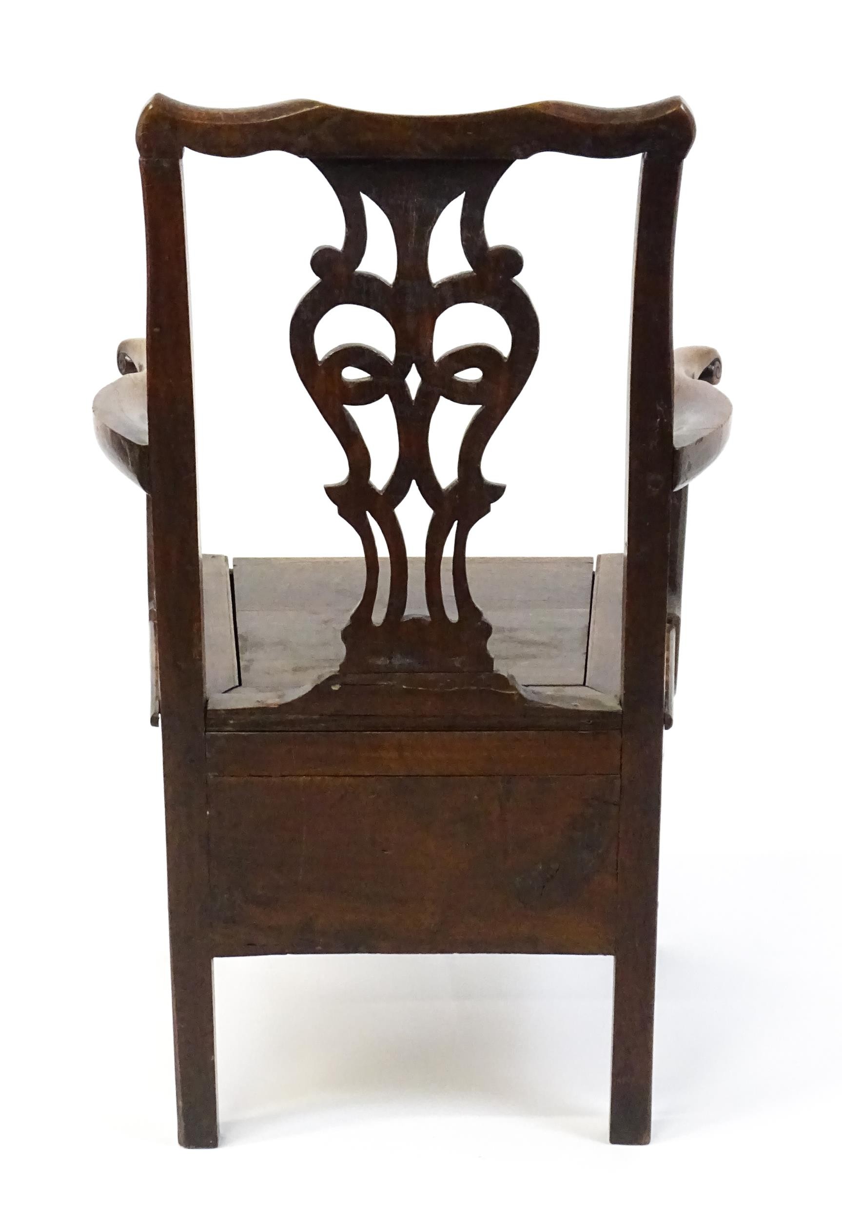 A late Georgian oak commode chair with a Chippendale style back splat above a hinged seat opening to - Image 10 of 10