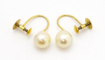 A pair of 9ct gold screw back earrings set with pearls Please Note - we do not make reference to the