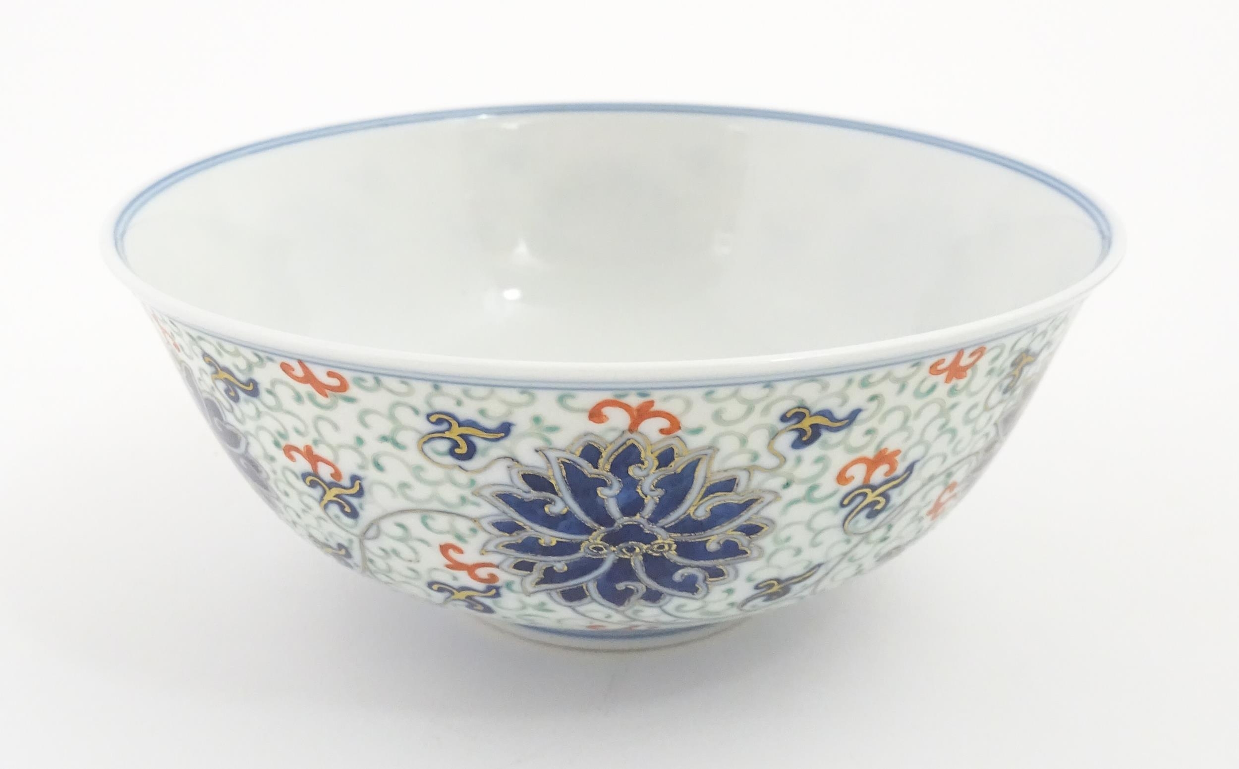 A Chinese bowl decorated with scrolling floral and foliate detail. Character marks under. Approx. 3" - Image 4 of 9
